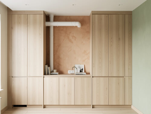 Petit appartement moderne où une goulotte de climatisation est discrètement intégrée dans un mur et dissimulée derrière un meuble encastré.